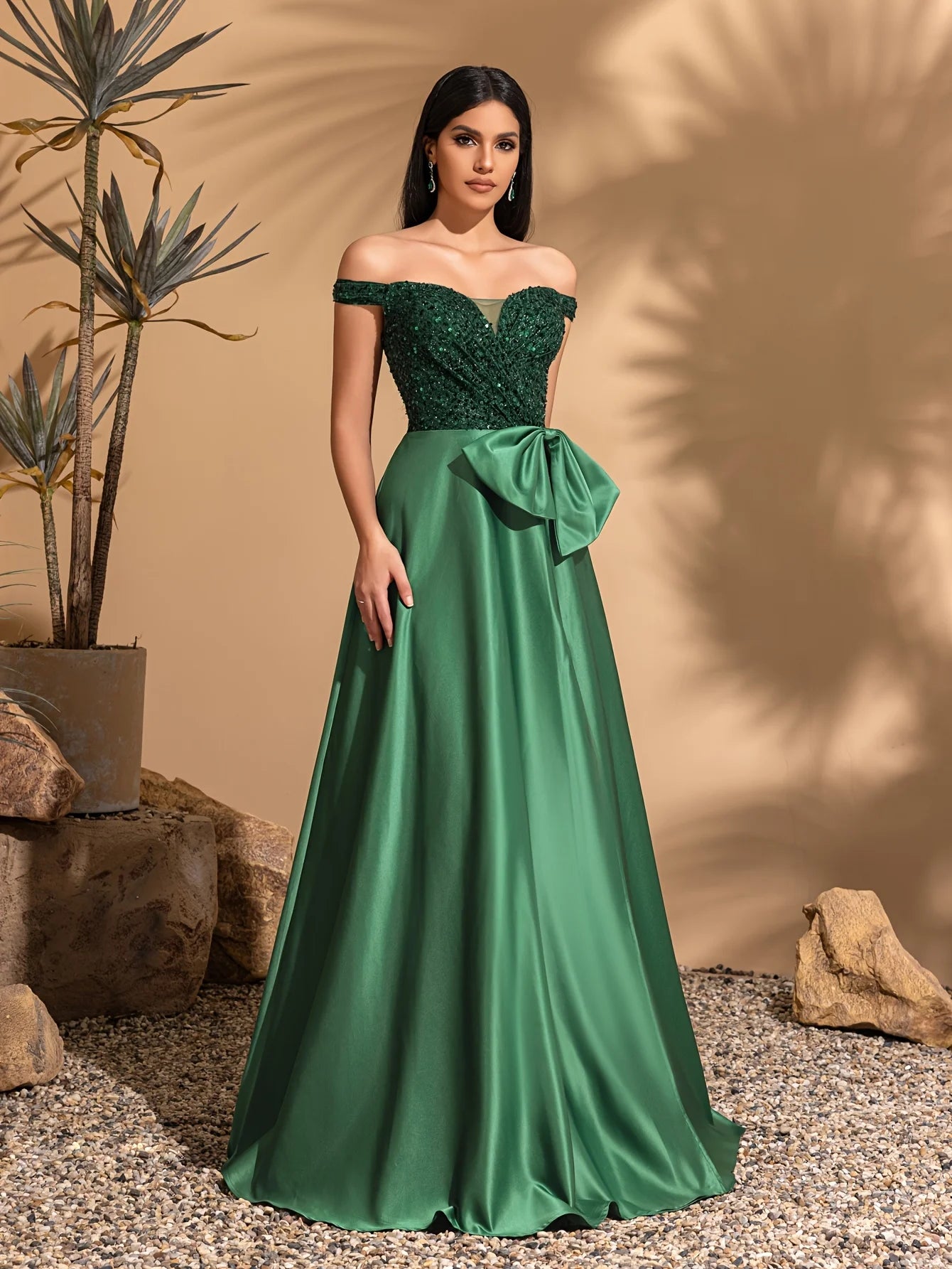 One-shoulder dress with bow decoration at waist and sequined satin hem